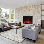 Modern great room with a floor to ceiling stone fireplace